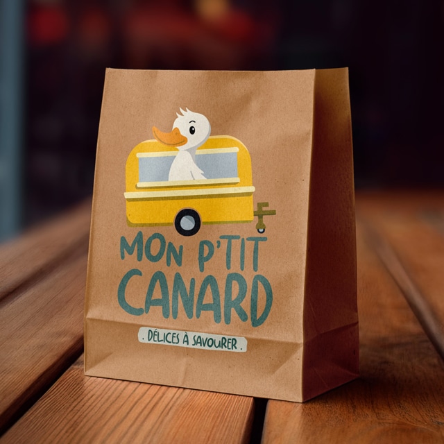 Sac en papier avec illustration de canard mignon.
