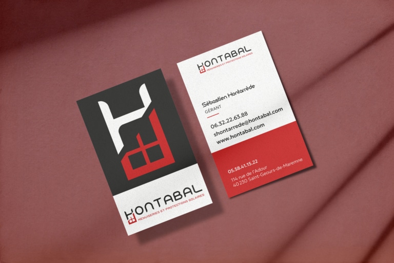 Cartes de visite Hontabal sur fond rouge.